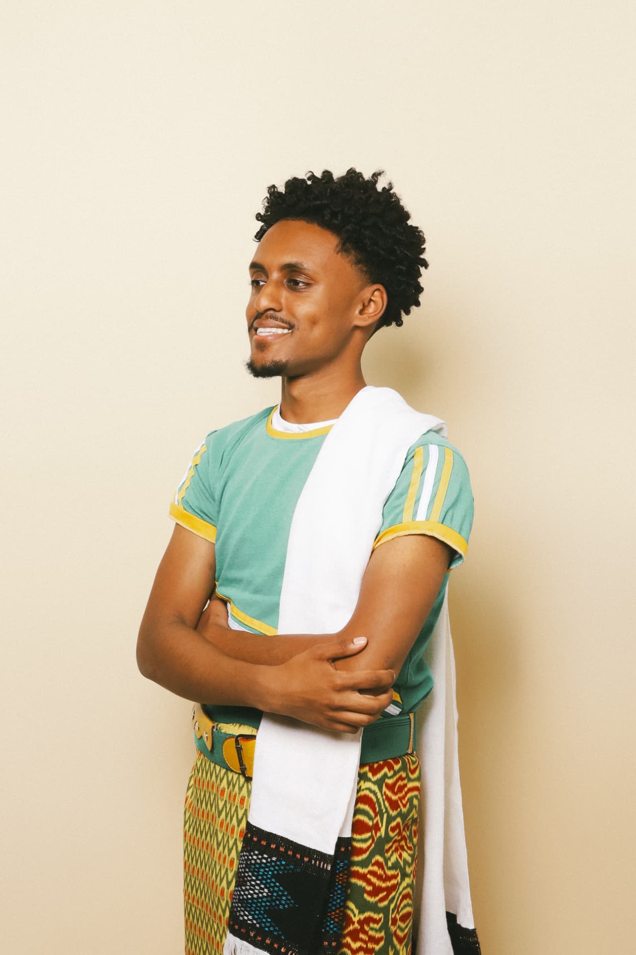 DJ KD smiling in cultural attire